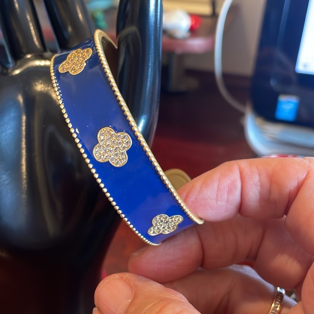 Blue enamel open bangle bracelet with brushed  gold tone trim.